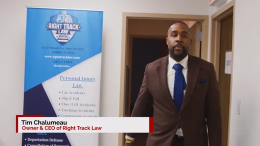 Tim Chalumeau standing next to a sign with the Right Track Law logo.